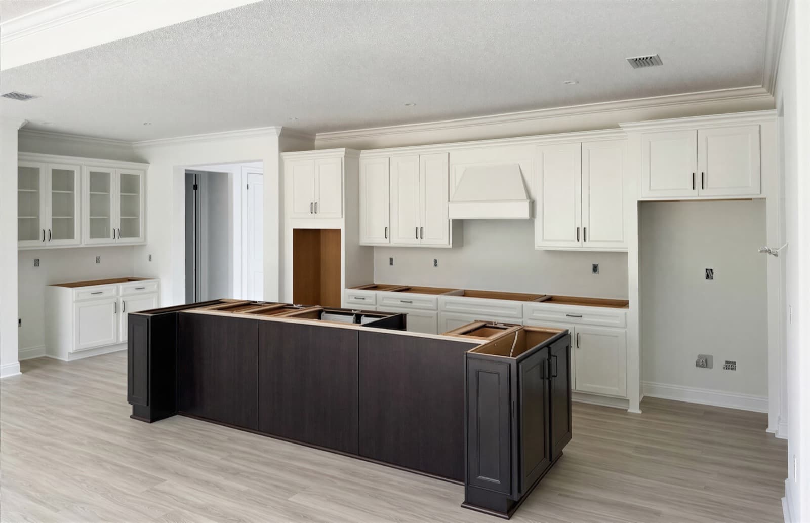 Two-Tone White & Espresso Kitchen, Orlando, FL. White perimeter, espresso island. Shown mid-install, before countertops.
